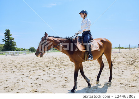 A woman practicing horse riding A woman practicing horse riding 124465802