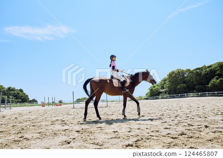 A woman practicing horse riding A woman practicing horse riding 124465807