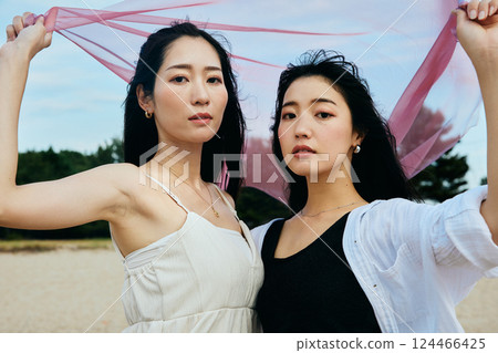Woman looking at the summer sea Woman looking at the summer sea 124466425