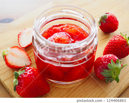 Sweet strawberry jam in a glass jar with fresh strawberries Sweet strawberry jam in a glass jar with fresh strawberries 124466863