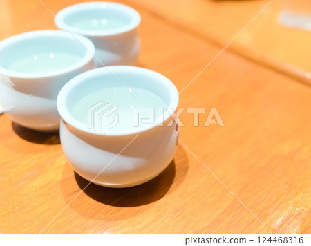 A moment of sharing a cup of sake and the warmth of it 124468316