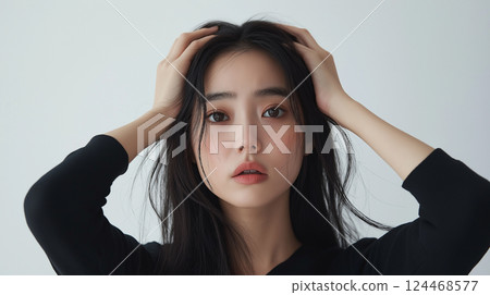 A woman in trouble holding her head 124468577