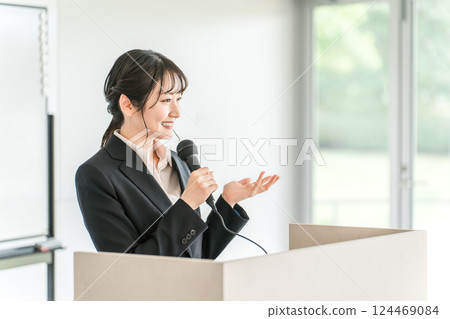 Businesswoman giving a presentation at a meeting, training session, or presentation 124469084