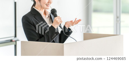 Businesswoman giving a presentation at a meeting, training session, or presentation 124469085