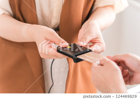 The hands of a woman making credit card payments, online payments, and cashless payments when shopping 124469829