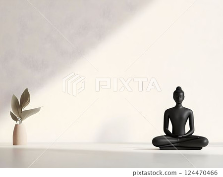Meditative black buddha statue sitting near potted greenery, sunlight casting soft shadows on minimalist white background 124470466