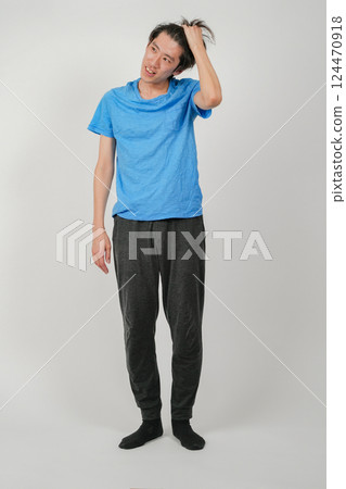 A cool Japanese man with his hair pulled back 124470918