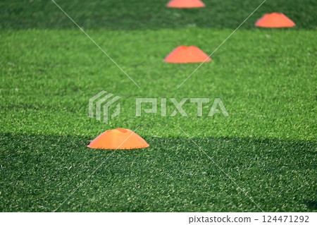 artificial green grass soccer field with training cones 124471292