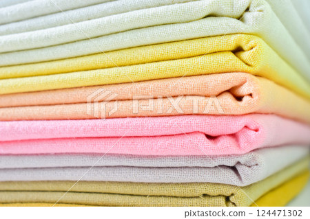 stack of colourful cotton clothes, close up pile of clothing stack of colourful cotton clothes, close up pile of clothing 124471302