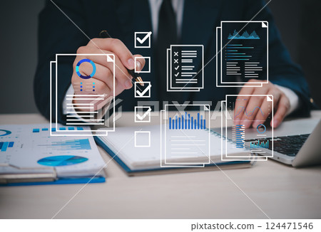 businessman working on a checklist marketing online with data charts and reports visualized digitally, representing task management and analytics. project planning, and business reporting. businessman working on a checklist marketing online with data charts and reports visualized digitally, representing task management and analytics. project planning, and business reporting. 124471546
