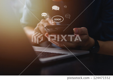 A person using a smartphone with chat icons floating, symbolizing online mobile technology, networking, and efficient communication in the digital world. customer support A person using a smartphone with chat icons floating, symbolizing online mobile technology, networking, and efficient communication in the digital world. customer support 124471552