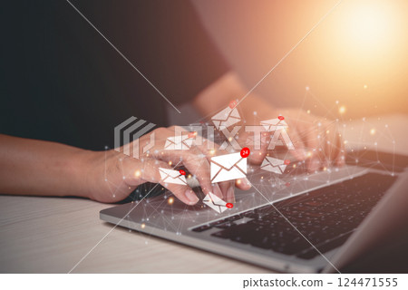 Hands typing on a laptop with digital email icons floating, online marketing communication and real-time notifications. Hands typing on a laptop with digital email icons floating, online marketing communication and real-time notifications. 124471555