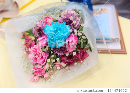 A bouquet of flowers to thank a teacher at a graduation ceremony A bouquet of flowers to thank a teacher at a graduation ceremony 124471622