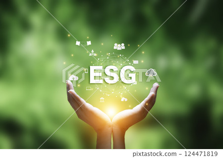 ESG icon at hand ,Net zero emission Idea innovation concept. Man using laptop analyzing ESG document data. Green energy.  Environmental, social,Governance. weather awareness global climate changes. 124471819