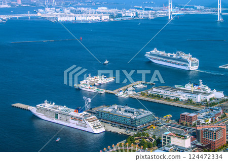 Yokohama cityscape in Japan, overlooking the Diamond Princess and other ships departing. In the foreground, Europa II is anchored and arriving for the first time. 124472334
