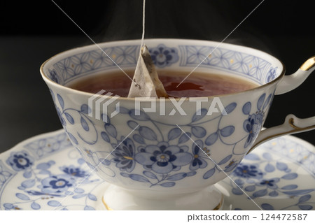Pouring tea into a cup using a tea bag 124472587