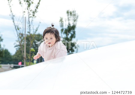 [Infants crawling on giant playground equipment] 124472739