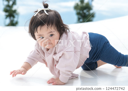 [Infants crawling on giant playground equipment] 124472742