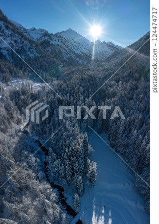 Aerial view with snowy forest and mountain river in the Bavarian Alps 124474717