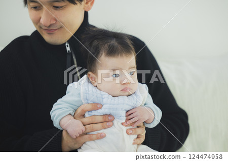 A family relaxing in the living room A family relaxing in the living room 124474958
