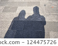 Silhouette of two people walking on the road 124475726
