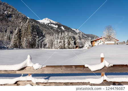 Winter landscape snow-covered nature and fence in the Bavarian Alps, Germany 124476087