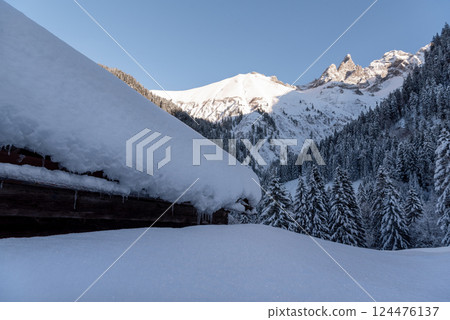 Snow-covered rustic mountain cabin in the Bavarian Alps, in Germany Snow-covered rustic mountain cabin in the Bavarian Alps, in Germany 124476137