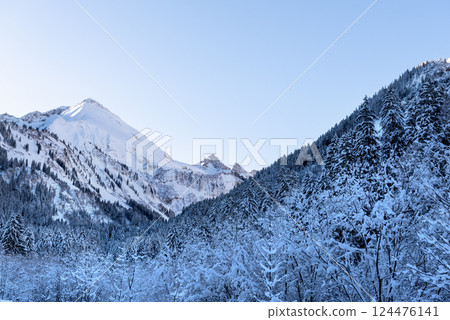 Winter landscape with snow-covered mountains and forest in the Bavarian Alps, Germany Winter landscape with snow-covered mountains and forest in the Bavarian Alps, Germany 124476141
