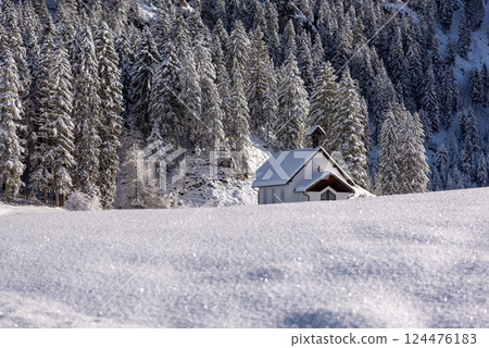 Snow-covered church, winter landscape on a sunny day in December Snow-covered church, winter landscape on a sunny day in December 124476183