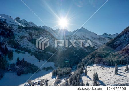 Winter sunny day in December, drone aerial view with snow covered pine forest and mountain peaks 124476206