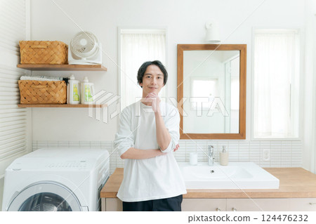 A man in his 30s smiling in the bathroom A man in his 30s smiling in the bathroom 124476232