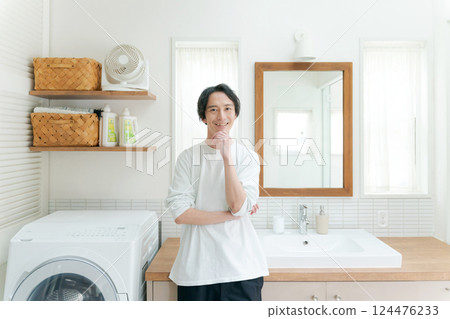 A man in his 30s smiling in the bathroom 124476233