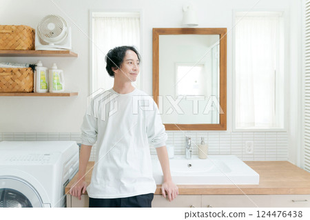 A man in his 30s smiling in the bathroom A man in his 30s smiling in the bathroom 124476438