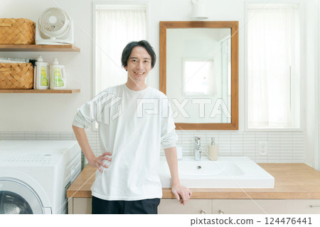 A man in his 30s smiling in the bathroom 124476441