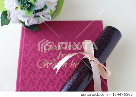 Diploma and cherry blossom petals 124476502
