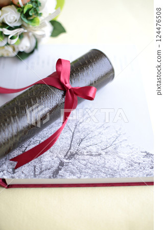 Diploma and cherry blossom petals Diploma and cherry blossom petals 124476508
