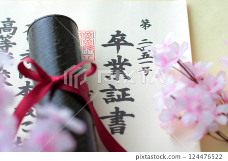 Diploma and cherry blossom petals 124476522