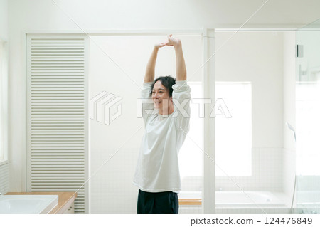 Young man stretching in the bathroom 124476849