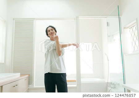 Young man stretching in the bathroom 124476857