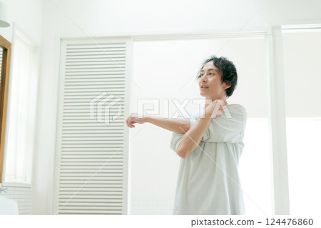 Young man stretching in the bathroom 124476860