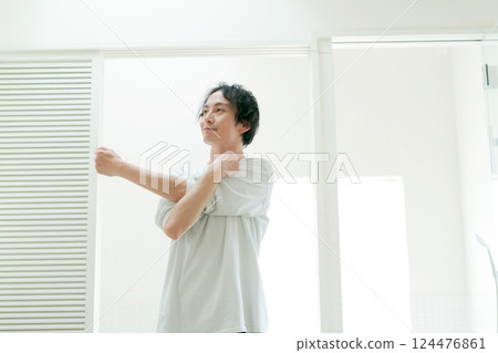 Young man stretching in the bathroom 124476861
