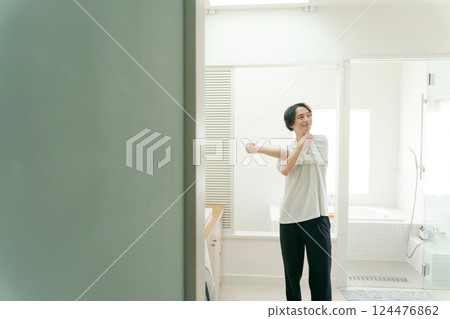 Young man stretching in the bathroom 124476862