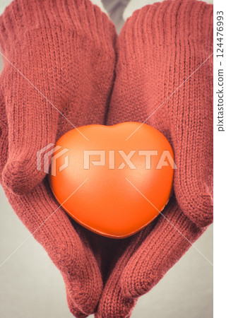 Hands of woman in gloves holding heart. Symbol of love and life Hands of woman in gloves holding heart. Symbol of love and life 124476993