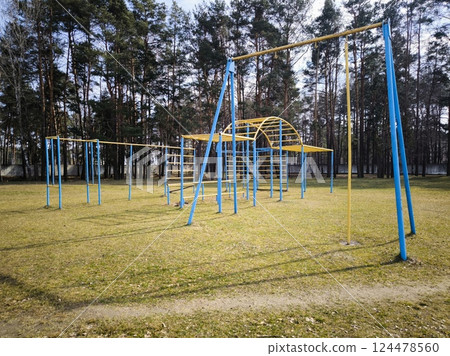 An empty playground in the park in spring. Horizontal bars for outdoor sports and athletics. 124478560