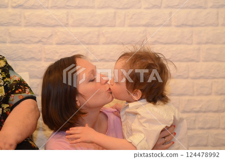 Mother and Child Sharing a Tender Kiss at Home 124478992