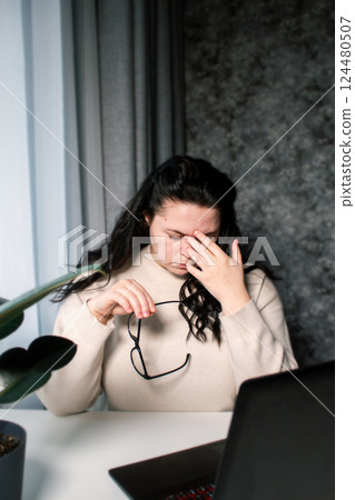 Tired business woman having fatigue and headache during work with computer. Female feeling stress and exhausted in office because of overwork 124480507