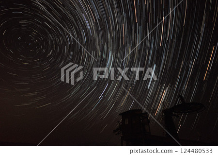 Star trails in the night sky and tranquil scenery 124480533