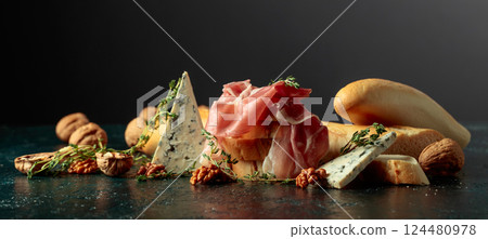 Delicate prosciutto with blue cheese, crispy baguette, crunchy walnuts, and fragrant thyme. 124480978