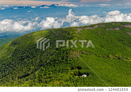 View of Tateshina Mountain Lodge and Mt. Asama from the summit of Mt. Tateshina in the Yatsugatake Mountain Range 124481859