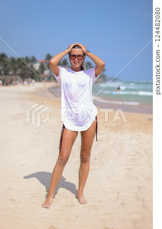 A Stylish Photo of Trendy Beachwear Showcasing a Beautiful Model Posing on the Shoreline A Stylish Photo of Trendy Beachwear Showcasing a Beautiful Model Posing on the Shoreline 124482080